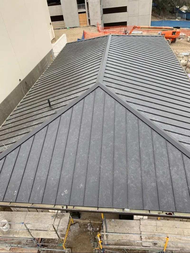 Commercial metal roof construction with crane equipment in Elmwood Park