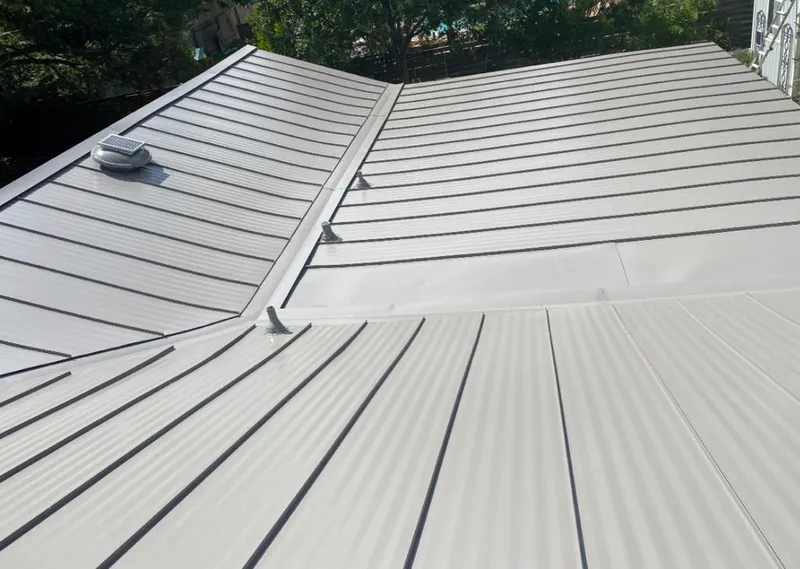 Solar attic fan installed on a metal roof for Roof Ventilation in Elmwood Park